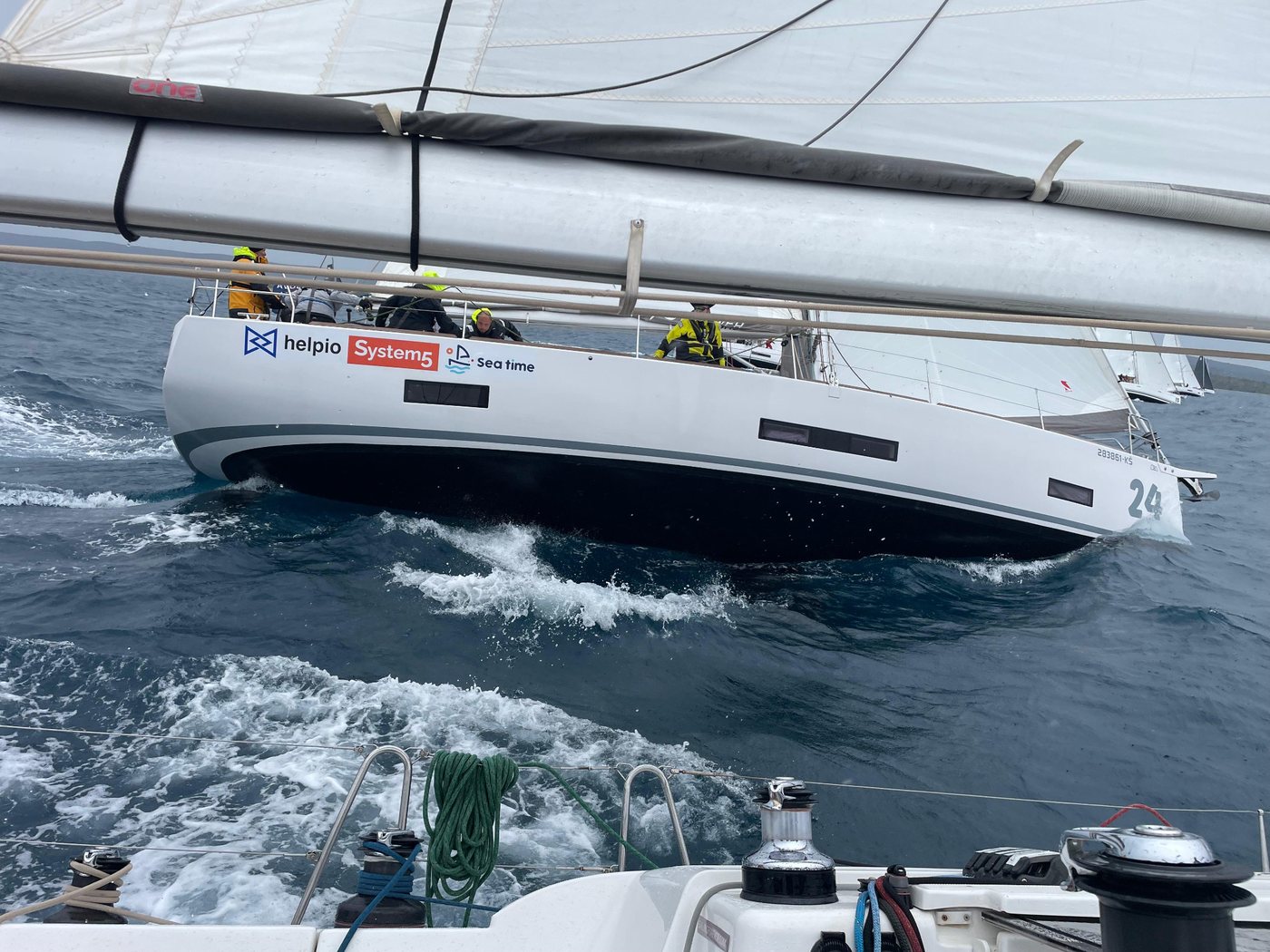 Close view of System5 branding on a yacht hull during sailing